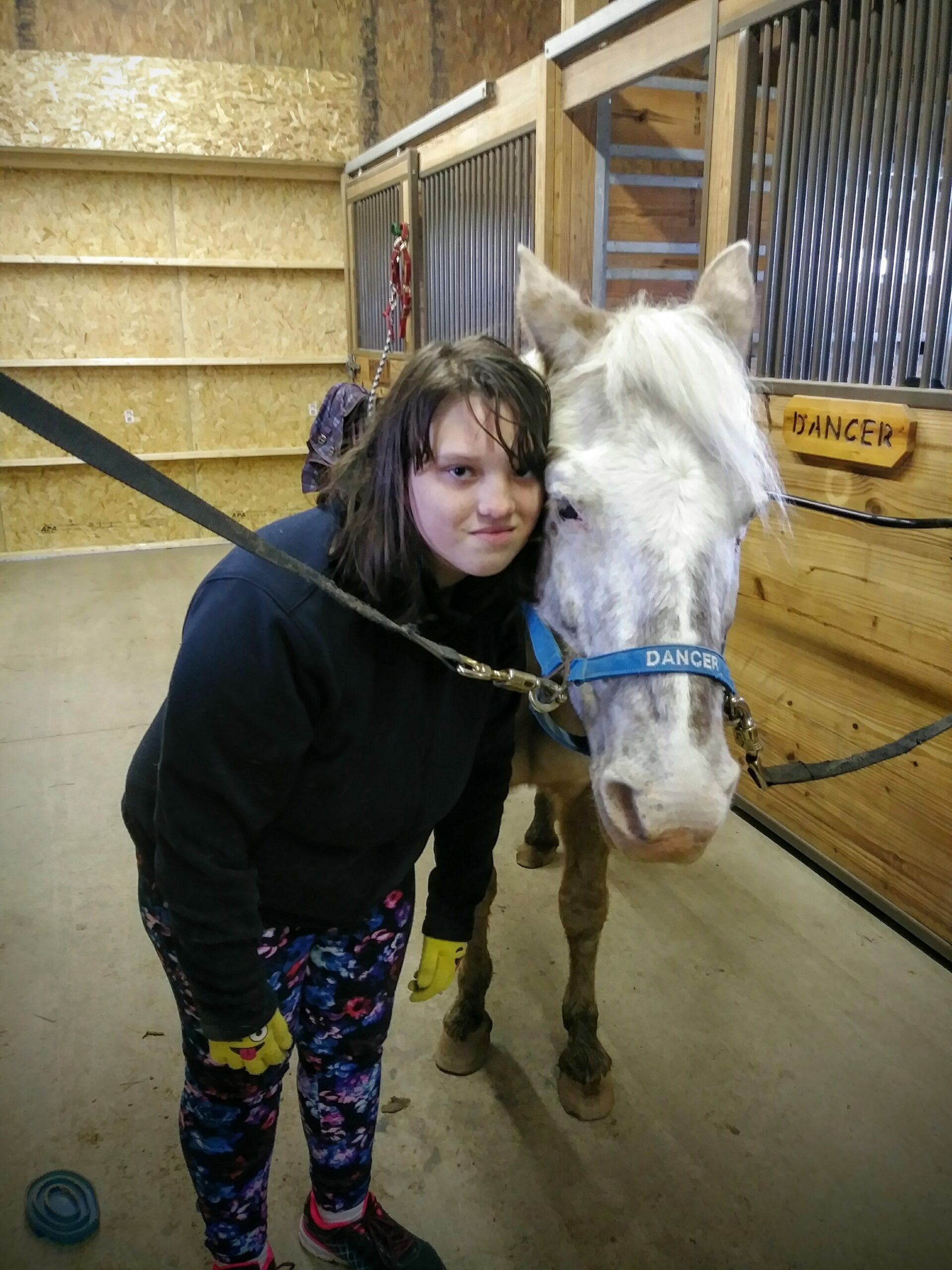 A person smiling with a horse